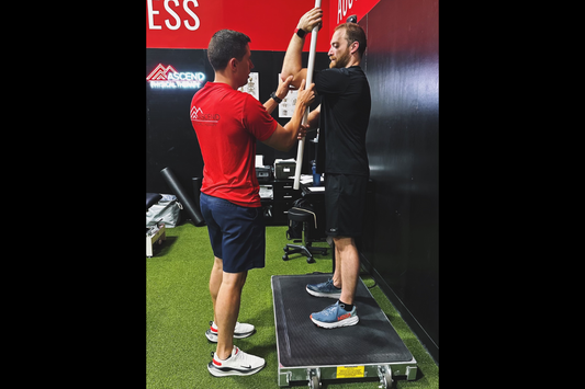 A user being helped with Physical Therapy exercises on Vibe-X at Ascend Performance